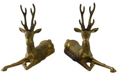 Lot 132 - A pair of Oriental brass models of recumbent...