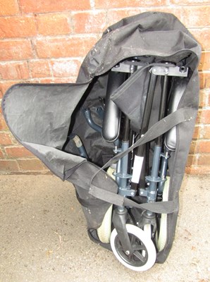 Lot 1094a - A folding wheelchair, contained in a carry bag.