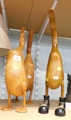 Lot 2005 - Three carved wooden ducks, one wearing boots.