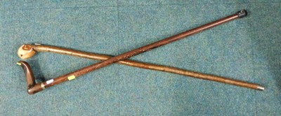 Lot 2114 - Two walking sticks, one with a wooden shaft...
