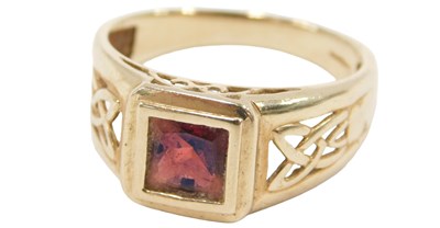 Lot 48 - A 9ct gold and garnet set ring, the square cut...