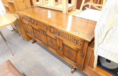 Lot 1561 - An oak Old Charm style sideboard, the base...