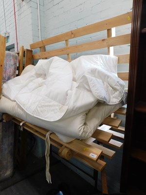 Lot 1581 - An Ikea pine sofa bed, with slatted seat and...