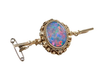 Lot 303 - An opal doublet bar brooch, oval scroll frame,...
