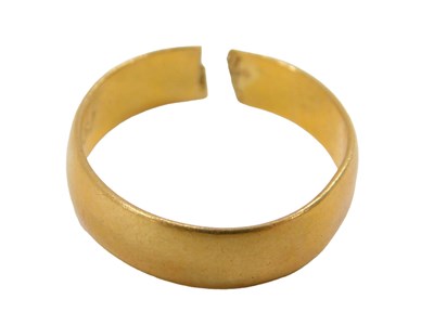 Lot 310 - A 22ct gold wedding band, cut, 3.5g.