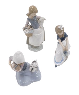 Lot 603 - A Lladro figurine of a young girl, carrying a...