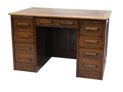 Lot 852 - A 1920s oak desk, with brown leather insert...