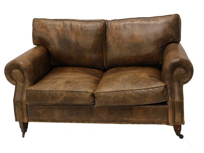 Lot 841 - A vintage finish brown leather two seater sofa,...