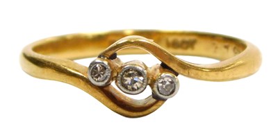 Lot 109 - A diamond three stone ring, in a cross over...