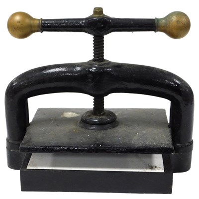 Lot 79 - An early 20thC cast iron book press, the screw...