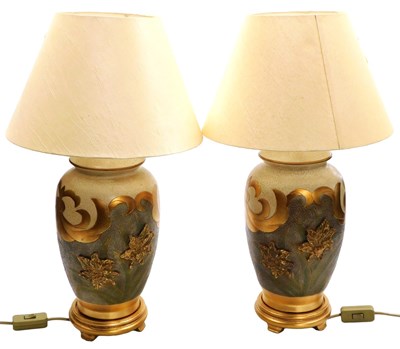 Lot 139 - A pair of cream and gilt table lamps, with...