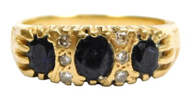 Lot 108 - A sapphire three stone ring, the oval cut...