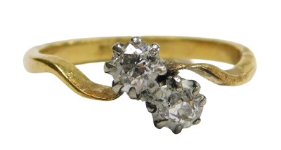 Lot 302 - A diamond two stone ring, in a crossover...