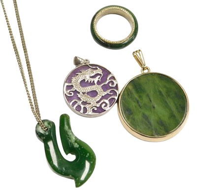 Lot 317 - Two Chinese jade pendants, one on a neck chain,...