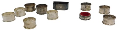 Lot 28 - A group of silver napkin rings, varying...