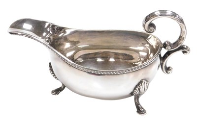 Lot 365 - An Elizabeth II silver sauce boat, with a...