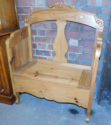 Lot 1006 - A pine monk's bench, with a scroll carved rail,...