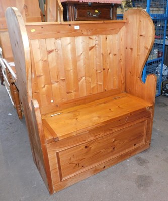 Lot 1007 - A pine monk's bench, with panelled back and...