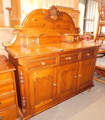 Lot 1019 - A pine sideboard, the top with a raised back...