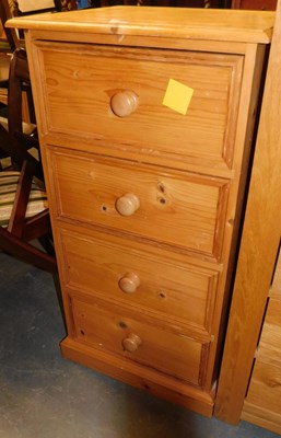 Lot 1133 - A 20thC pine four drawer narrow chest, on a...