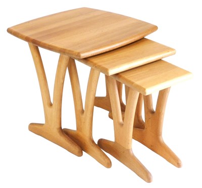 Lot 436 - A light oak nest of occasional tables, raised...