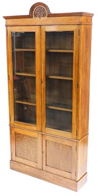 Lot 450 - A Victorian oak cupboard bookcase, with a...