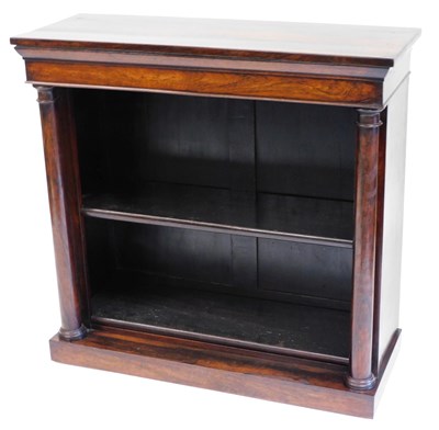 Lot 454 - A late Regency rosewood bookcase, the outswept...
