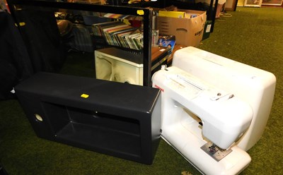 Lot 2176 - A cased sewing machine, together with a black...