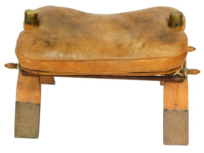 Lot 504 - A 20thC camel stool, brass capped, with a tan...