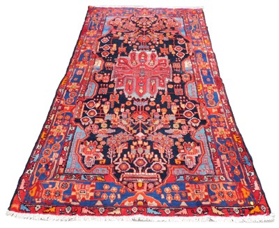 Lot 533 - A Nahawand black ground rug, with a central...