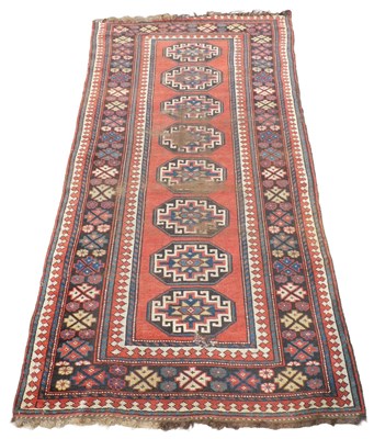 Lot 535 - A Kurdish red ground rug, decorated with eight...