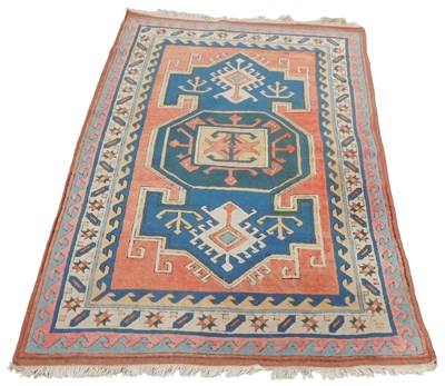 Lot 536 - A Turkish blue and red ground rug, decorated...