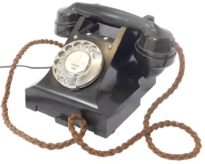 Lot 217 - A black Bakelite cased dial telephone, 106cm...