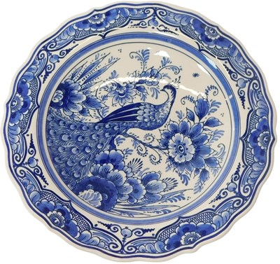 Lot 241 - A 20thC Delft plate, decorated with a peacock...