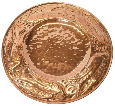 Lot 242 - An Arts and Crafts copper charger in Newlyn...