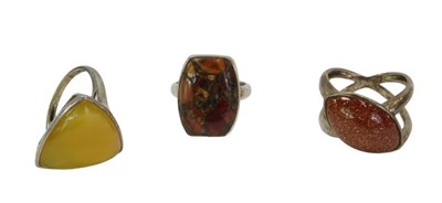 Lot 377 - Three dress rings, each hardstone set, with a...