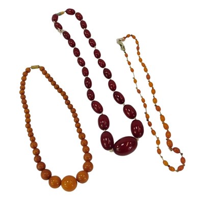 Lot 290 - Three amber style necklaces, comprising a...
