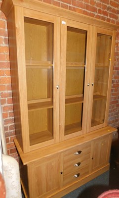 Lot 1001 - A display cabinet, the cornice over three...