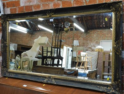 Lot 1060 - A rectangular bevelled mirror, with gilt...