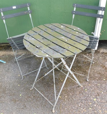 Lot 1119 - A bistro set, comprising two folding chairs...