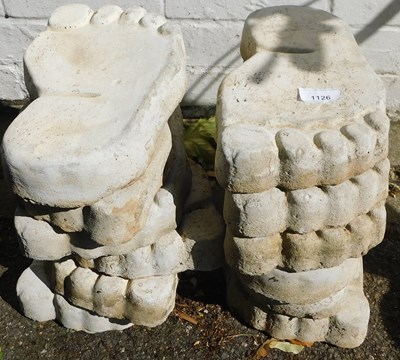 Lot 1126 - A set of garden ornaments in the form of feet.