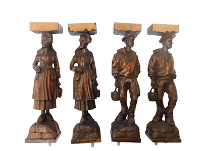 Lot 401 - Four carved walnut figural supports, two...