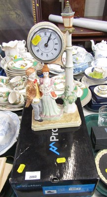 Lot 2060 - A ceramic quartz mantel clock, figural, and a...