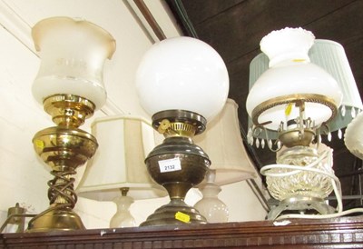 Lot 2132 - Three oil lamps, converted to electricity....