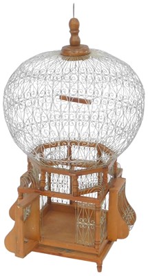 Lot 563 - A 20thC pine and wirework bird cage, 77cm high.