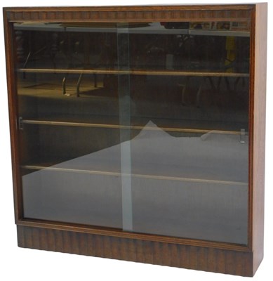 Lot 610 - An early 20thC oak display cabinet, with two...