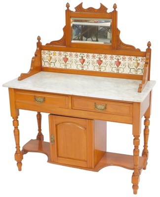 Lot 632 - A Victorian walnut washstand, the raised back...