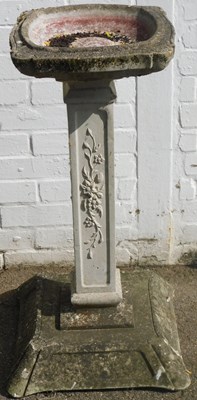 Lot 551 - A composition stone garden birdbath, the...