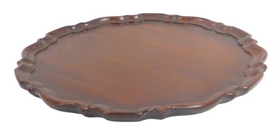 Lot 588 - A mahogany piecrust tabletop, lacking a base,...