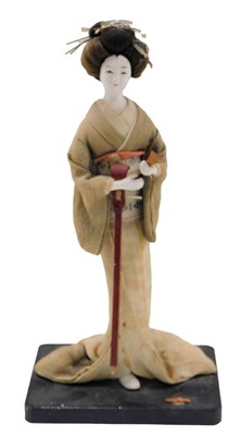 Lot 260 - A Japanese ceramic figure of a Geisha, wearing...